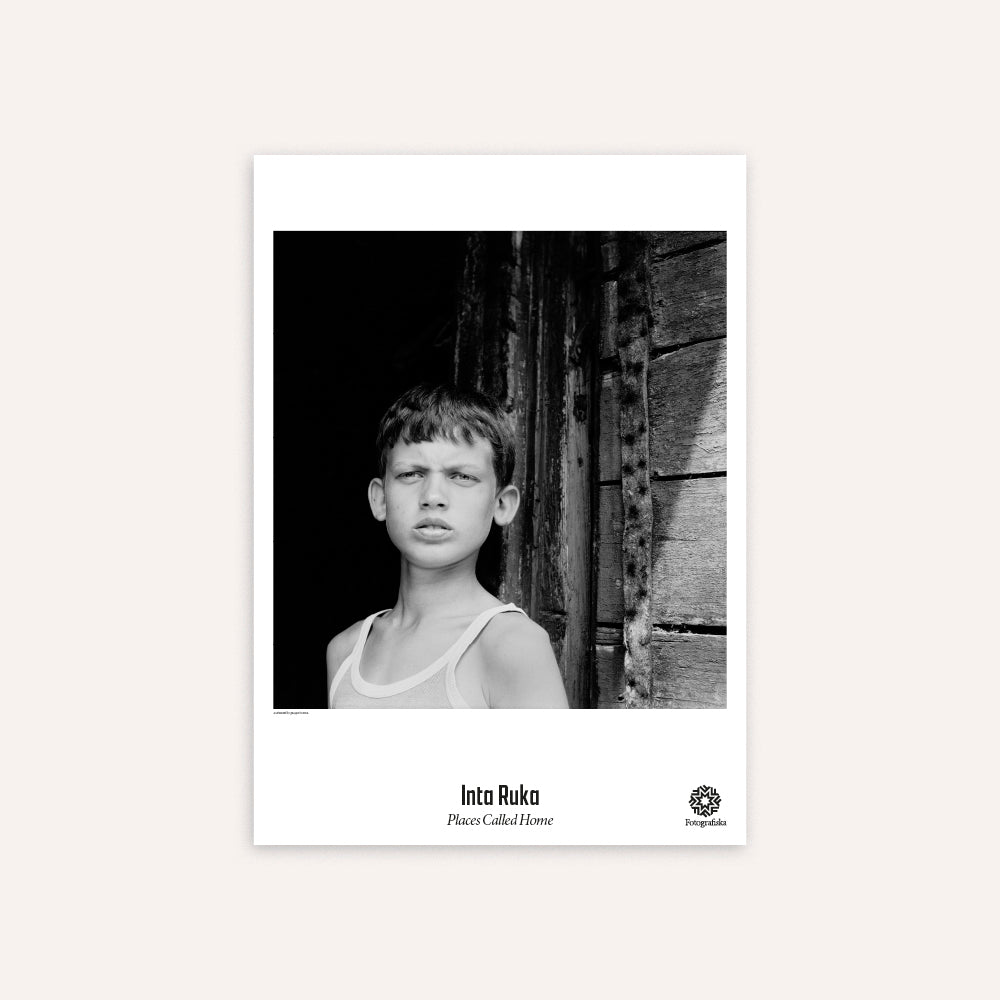 Black and white poster of a young boy by Inta Ruka. 