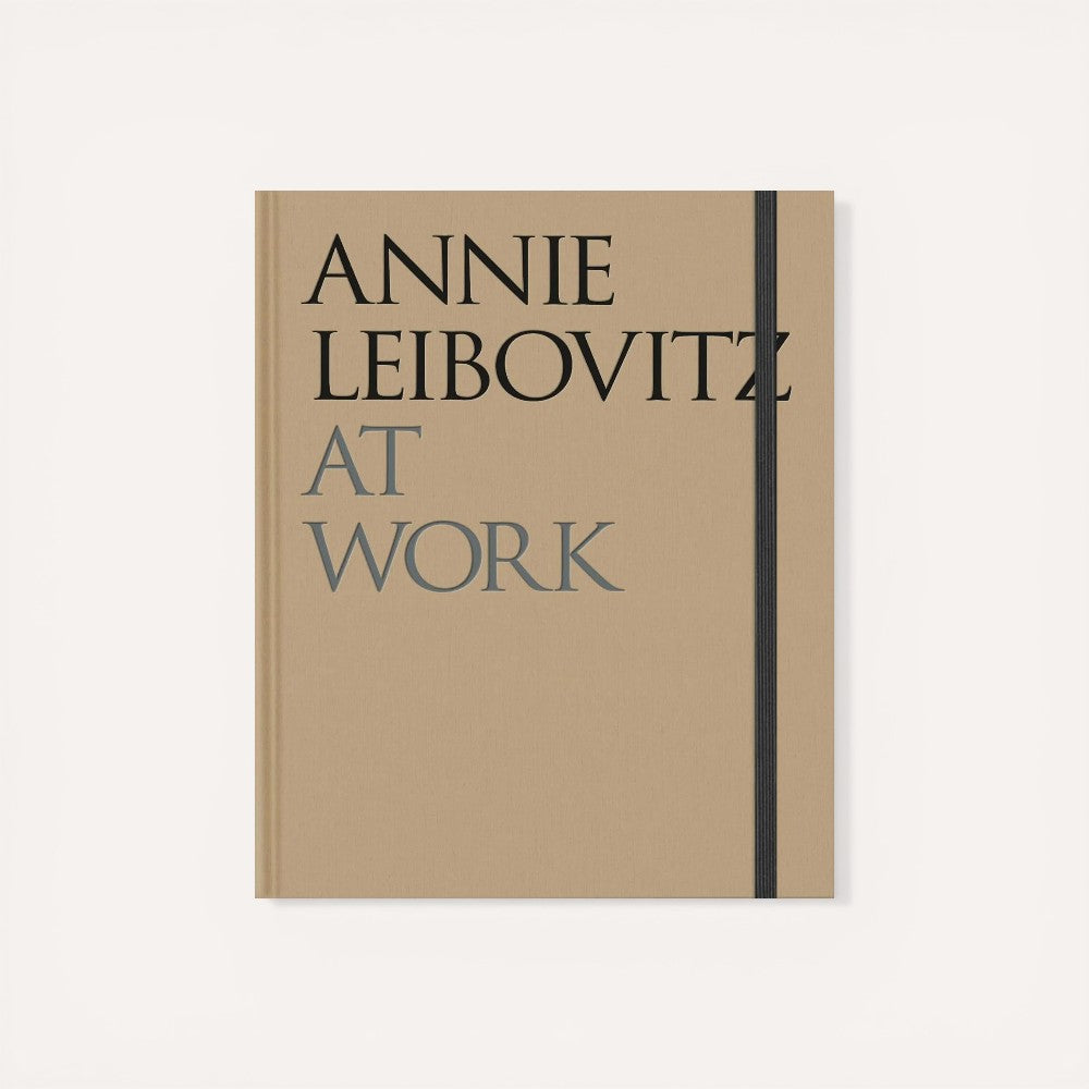 Book titled 'Annie Leibovitz at Work' with a beige cover and black text.