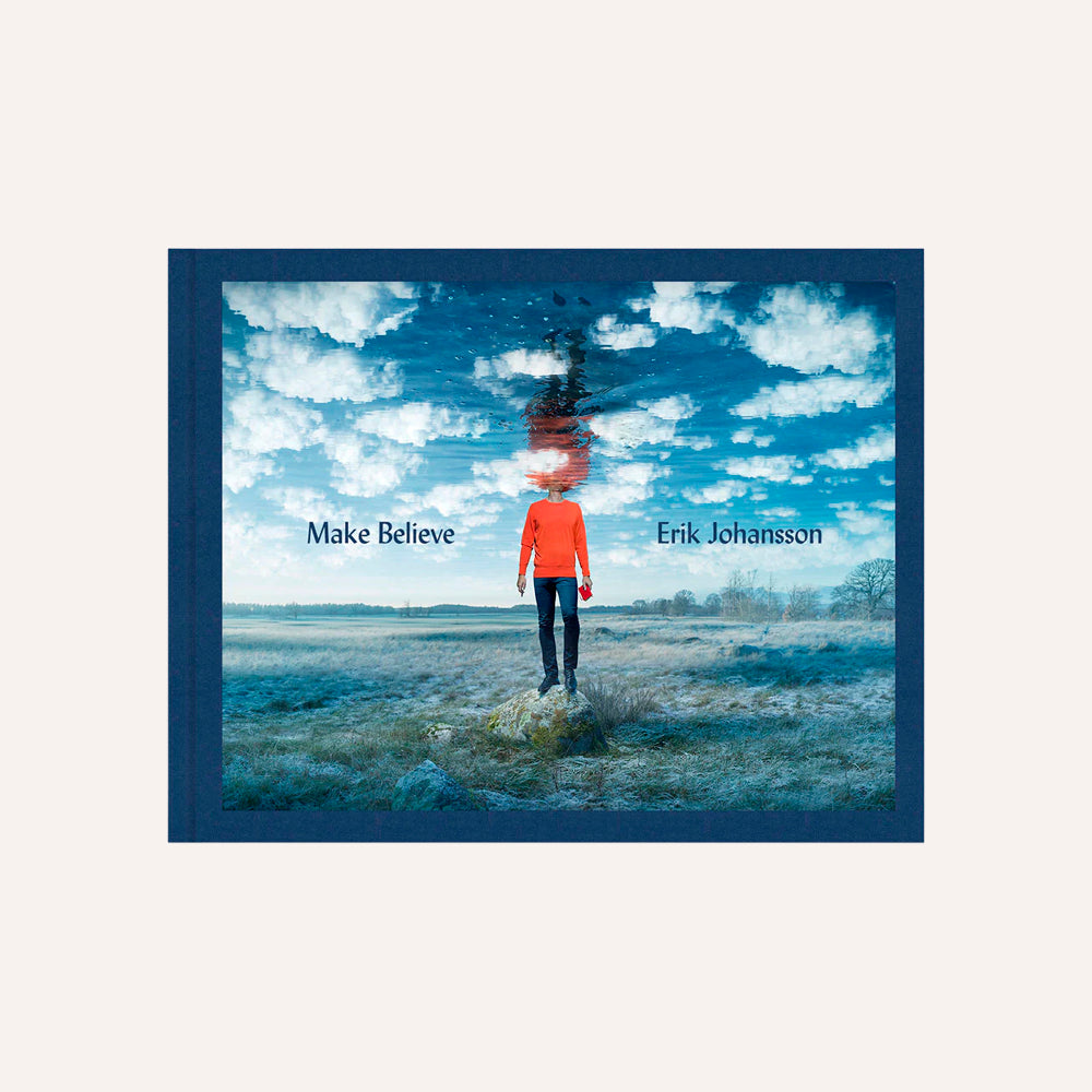 Book cover with a person in an orange jacket standing in a field under a blue sky with clouds, featuring the text 'Make Believe' by Erik Johansson.