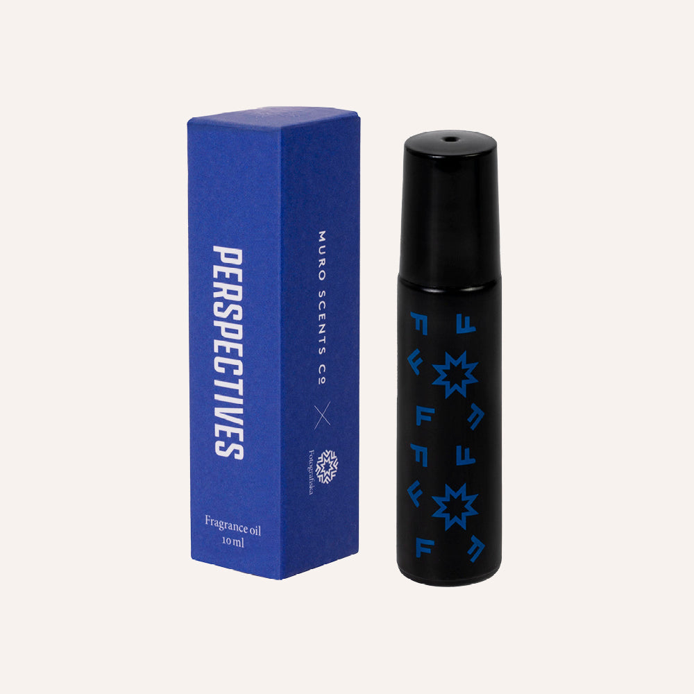 Black fragrance oil bottle with blue star patterns next to a blue box labeled 'Perspectives' on a white background