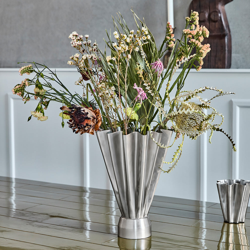 Silver vase with flowers. 