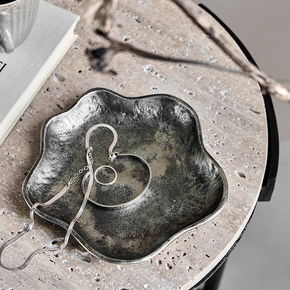 Silver jewelry on a tray. 