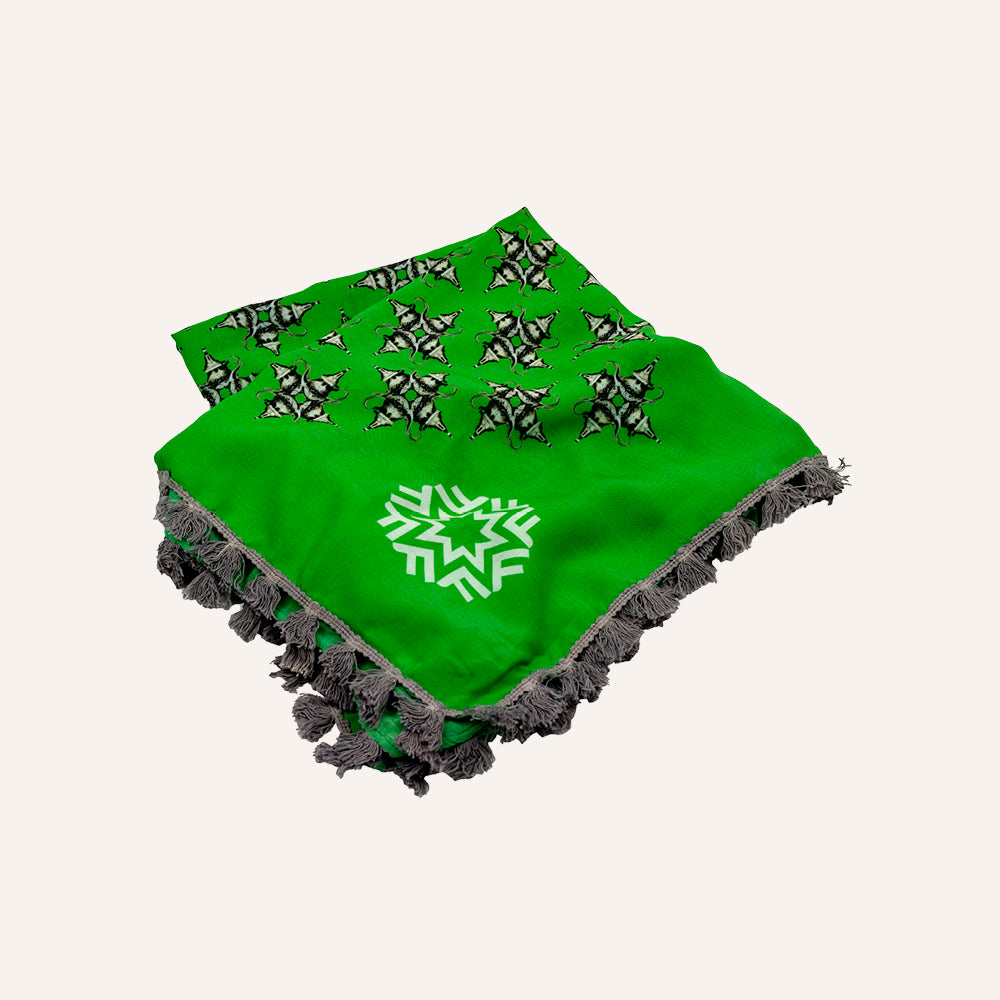 Green scarf with black and white patterns on a white background