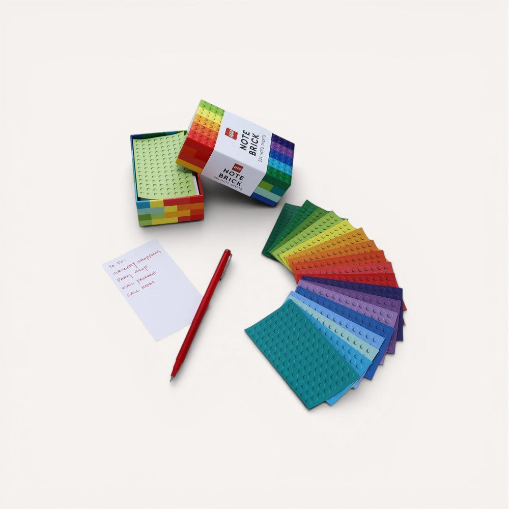 Colorful building block-style note pads with a pen on a white background