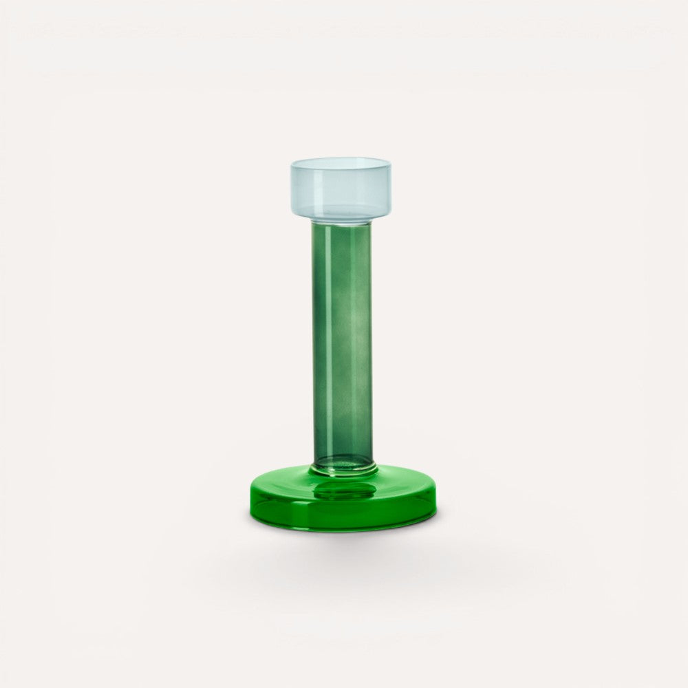 Green cylindrical candle holder with a clear top. 