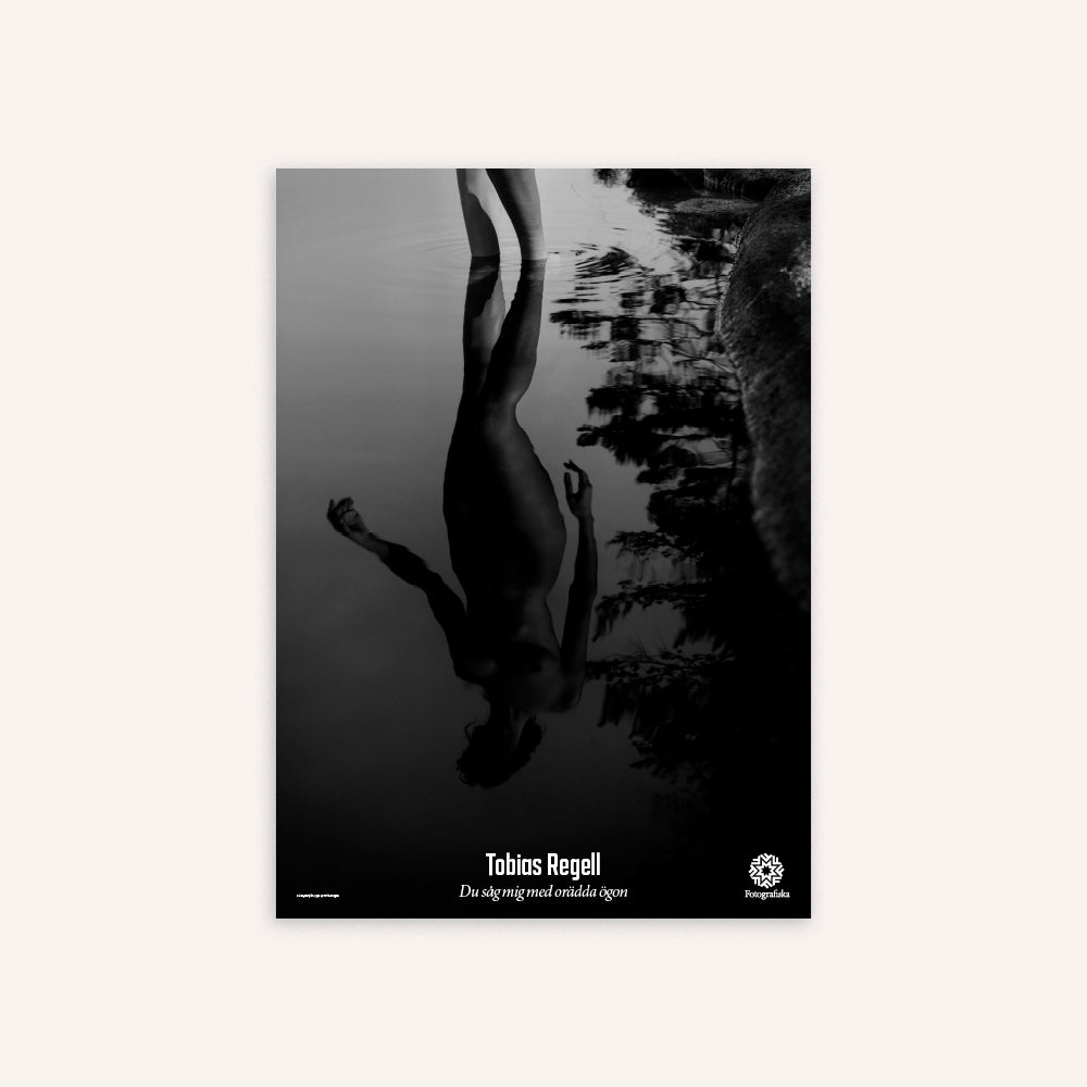 Black and white album cover with a person underwater and reflected trees.