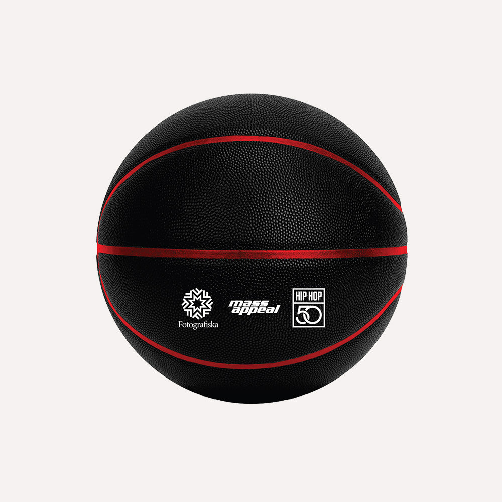 Black basket ball with red stitching.